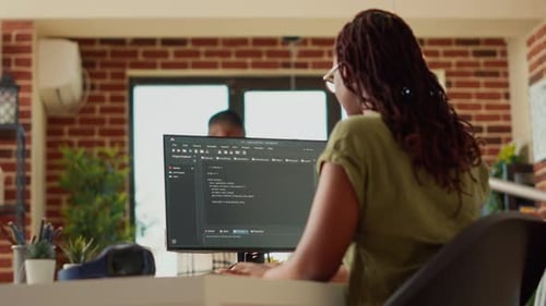 Woman Typing at Computer Indoors