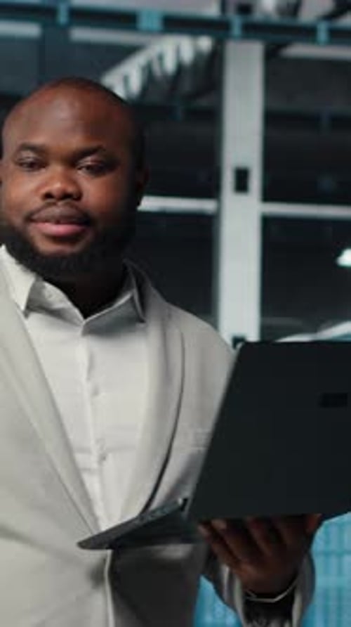 Vertical Video Data Center System Administrator Reviewing Code for Automation Scripts