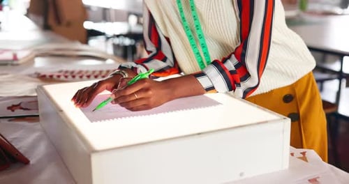 Hands, fashion drawing and tailor in office for clothes style on light box closeup