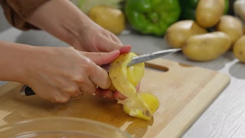 Preparing fresh potatoes for cooking in the kitchen
