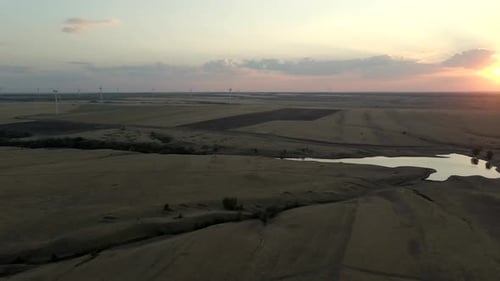 Windmills Generating Electric Power at Sunset in an Expansive Windmill Park Showcasing Green Energy