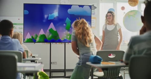 Geography Class Female Teacher Teaching Primary School Children Using Digital Screen