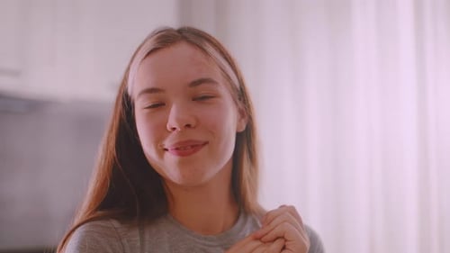 Teenage Girl Smiling in a Bright Indoor Setting