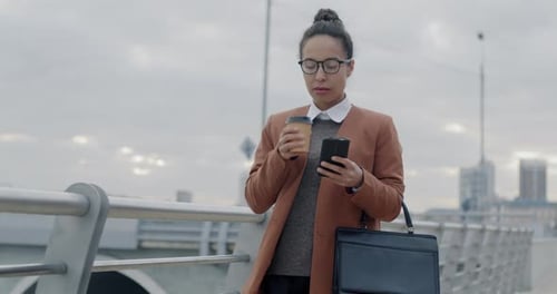 Slow Motion of Successful Young Biracial Lady Walking Along City Street Drinking to Go Coffee and