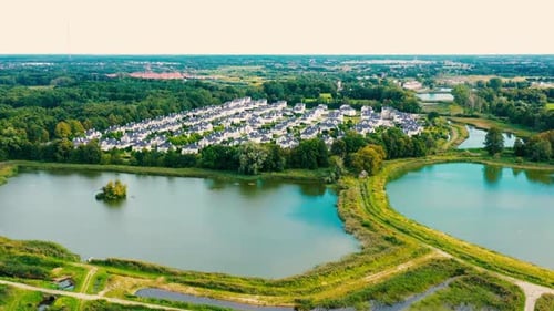 Aerial footage typical suburban housing estates with rows of houses, taken on a bright sunny day usi