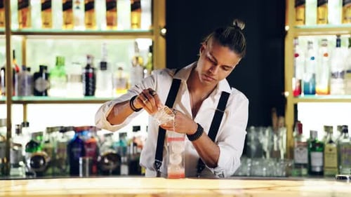 Professional Bartender Preparing a Creative Alcoholic Drink in a Bar