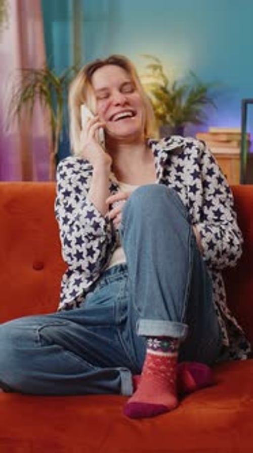 Woman on Couch Talking on Phone Expressively
