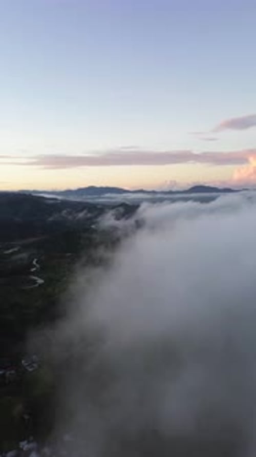 Vertical Drone Footage of fog in the mountain at Gorontalo, Indonesia