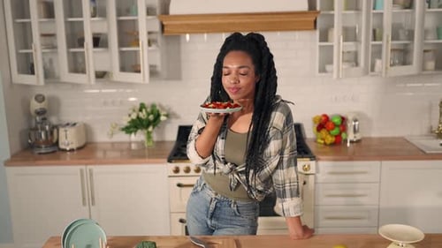 Smiling Woman with Salad in Bright Kitchen