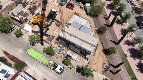 Pre-fabricated modular house construction site. Aerial top-down drone circling