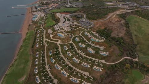 Pylos, Greece - 01 December 2024: Aerial view of golf course and hotel along coastline, Greece.