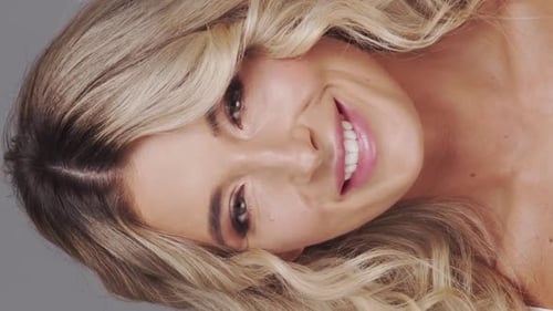 Studio Portrait of Young and Beautiful Blond Woman Over Grey Background Skin Care and Wellness