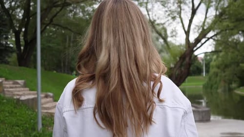 Rear View Blonde Girl Head Walking Through Summer Park
