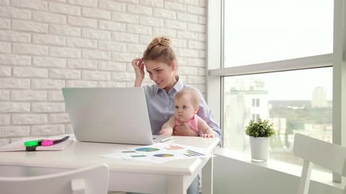 Businesswoman with Kid on Hands Working with Documents. Beautiful Mother Working On