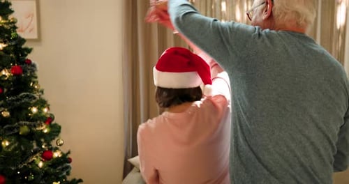 Senior Couple Dancing at Christmas at Home