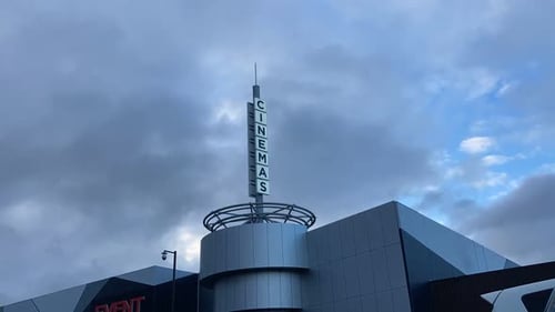 timelapse of cinemas sign with cloud moving