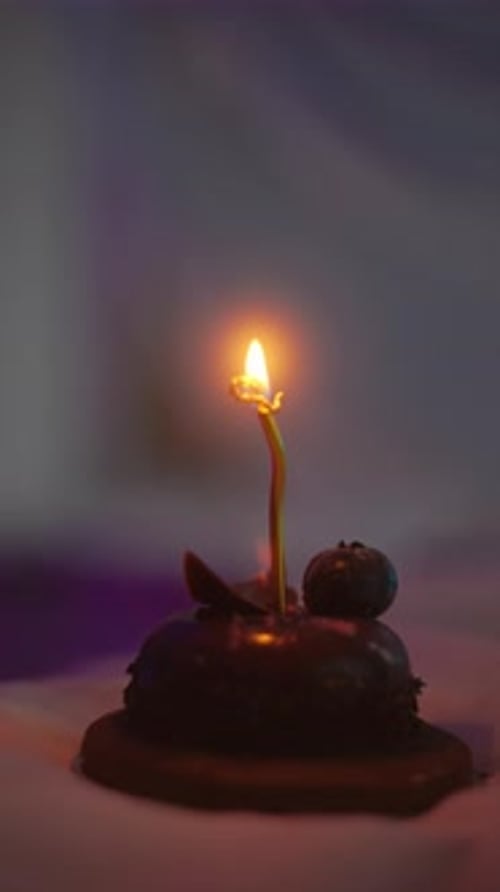Candlelit Dessert A Satisfyingly Elegant Chocolate Cake Glowing with a Flickering Flame for Special