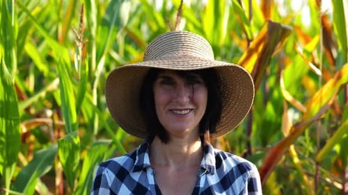 Happy Smiling Female Farmer Looks Into Camera Standing Near Corn Field Portrait of Adult Beautiful