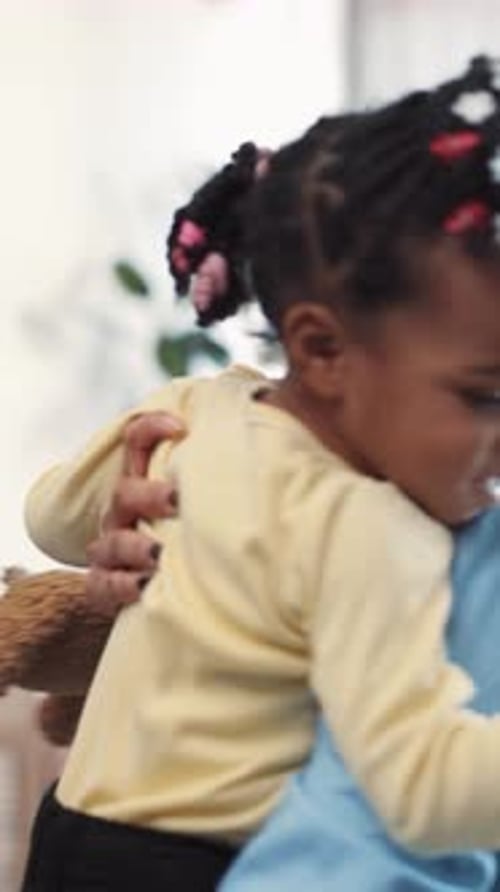 Adult Holding a Child Indoors