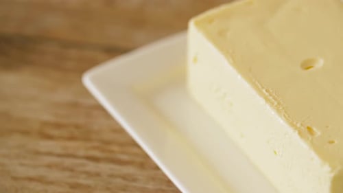 Food and Dairy Products Concept - Close Up of Butter on Wooden