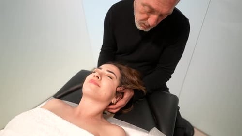 Chiropractor Massaging Woman's Neck for Pain Relief