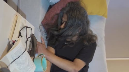 Man with Long Hair Lays on Couch