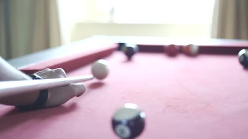 Potting a solid colour on the snooker table.