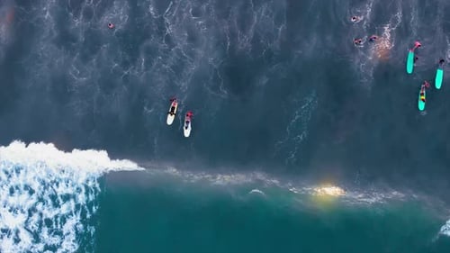 Aerial View of Surfers and Waves at the Beach
