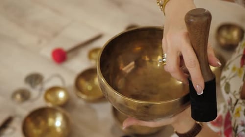 Woman Plays Singing Bowl for Meditation