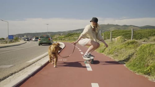 4k Slow Motion Young Happy Girl Skateboarding With Dog Near Mountains v2