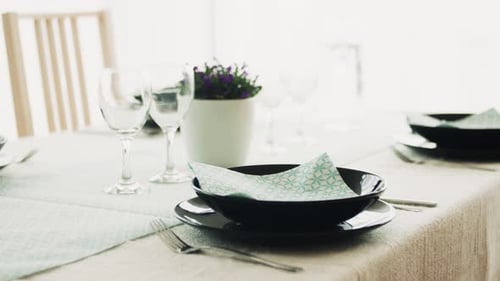 Dining Table Setup with Modern Dishes and Elegant Design