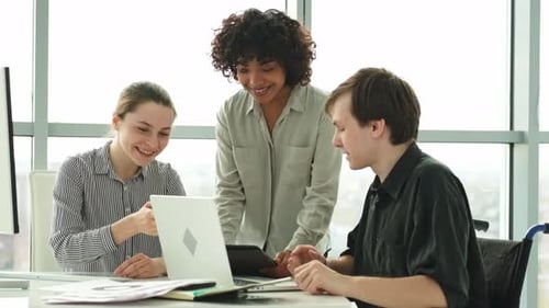 Team Working Together at Table in Office