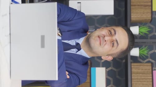 Man Working on Laptop in Vertical Format
