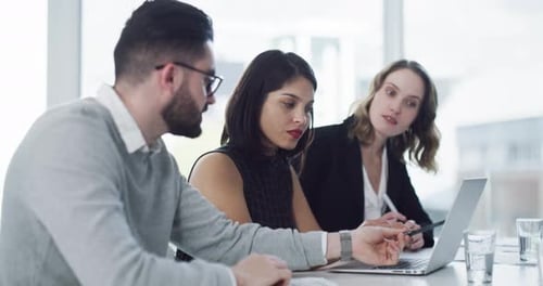 4k video footage of a group of businesspeople working together on a laptop in an office