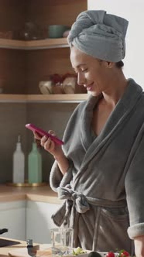 Pretty Woman Typing on Smartphone While Cooking Breakfast Beautiful Caucasian Female Prepare Healthy