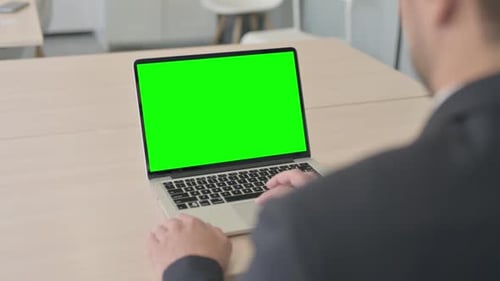Businessman Using Laptop with Green Screen