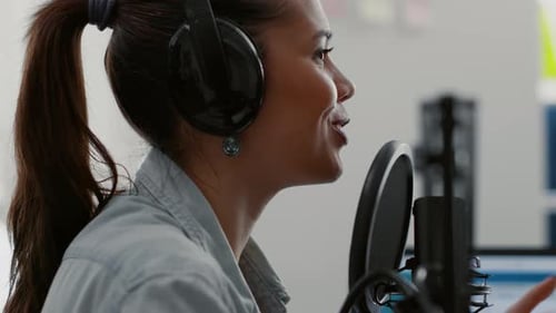 Attractive Talk Show Host Broadcasting While Talking to Audience in Home Studio