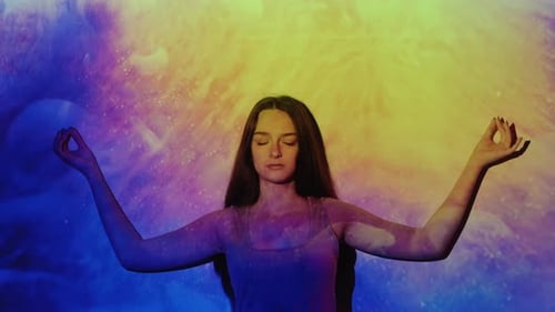 Woman Meditating with Colorful Abstract Background