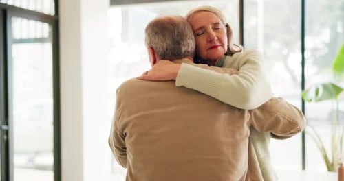Loving Older Couple Embrace Affectionately in Modern Home