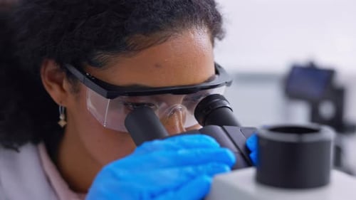 Woman Working in Lab with Microscope