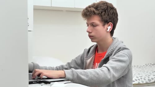 Teenager Using Laptop Computer at Home