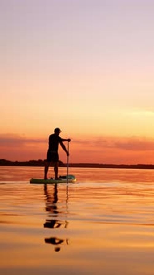 Paddleboarding at Sunset on Calm Water