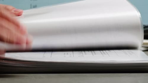 Flipping Through Financial Report Pages in Office
