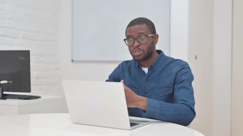 Young Adult On Video Call in Office Setting