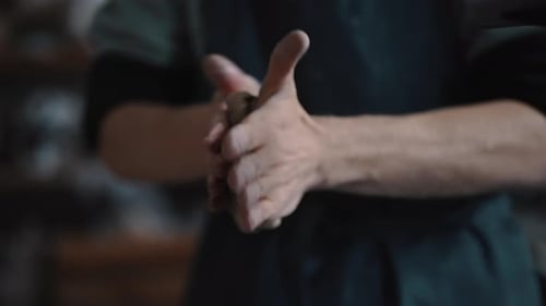 Cropped View of Hands of a Sculptor Artisan Modelling and Shaping a Wet Clay in His Crafts Workshop