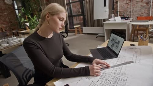 Female Architect Drawing Floor Plan and Reviewing Digital 3D House Design