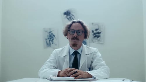 Portrait of Doctor Sitting at Desk in Psychiatric Hospital Ward