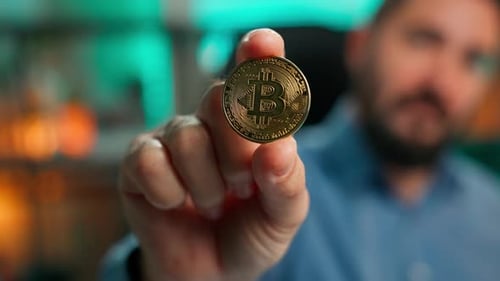 Hand Holding a Bitcoin Crypto Currency Gold Coin