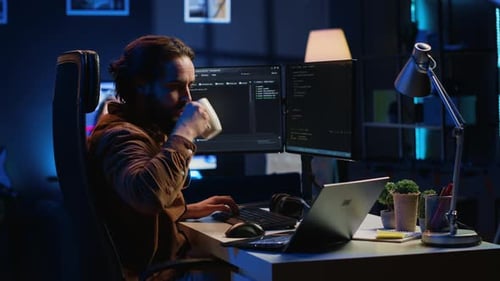 IT Professional Doing Multitasking in Apartment Office While Listening Music
