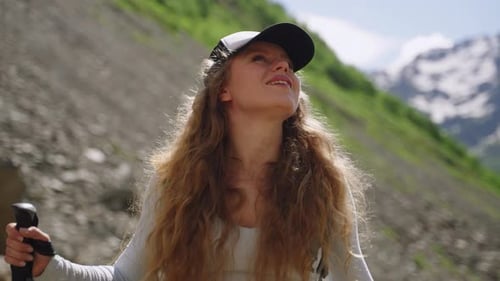 Young Woman Hiker with Backpack Stops to Enjoy Scenic Mountain View Female Traveler in Nature